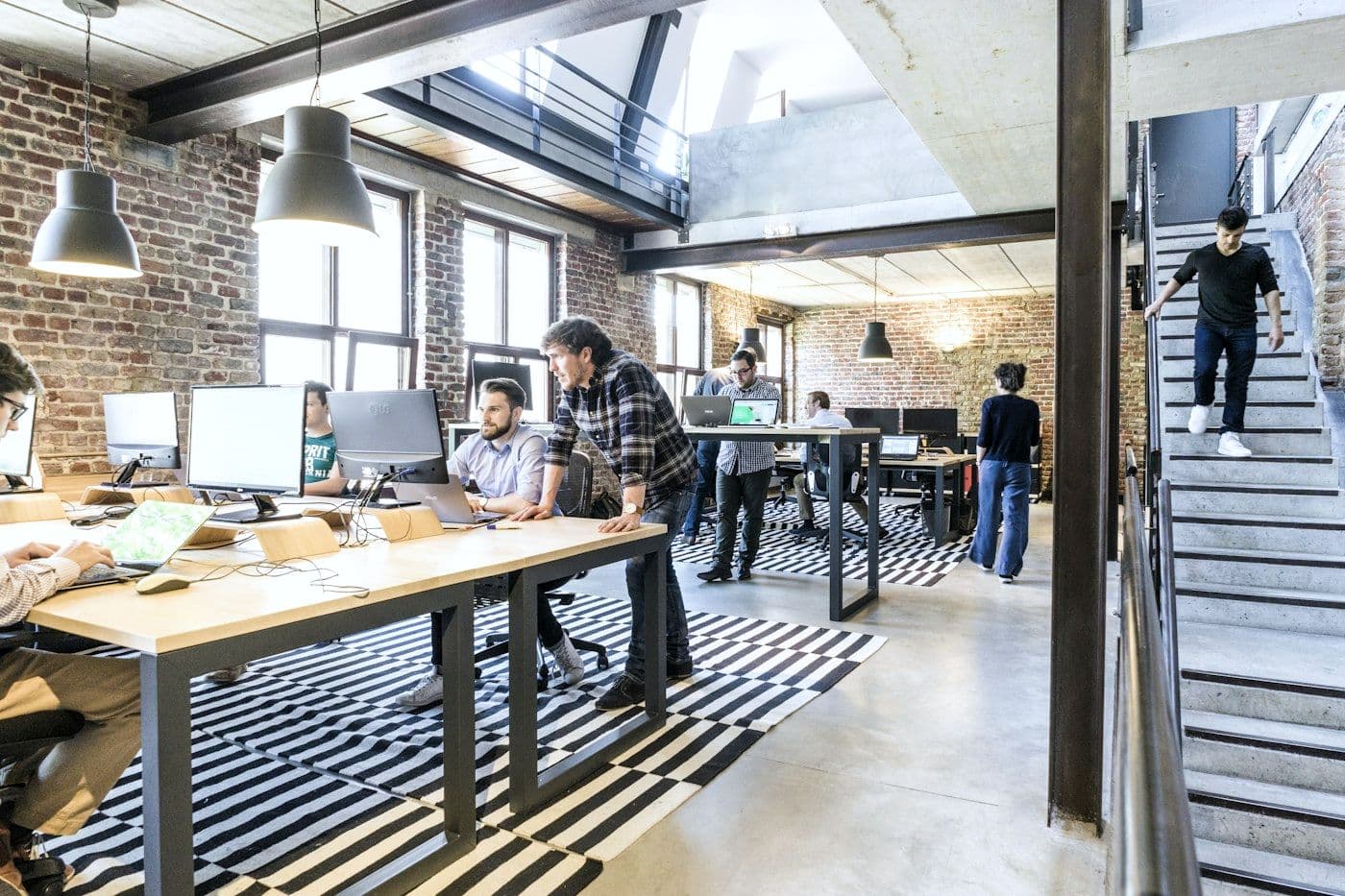 A bright loft office with people at work.