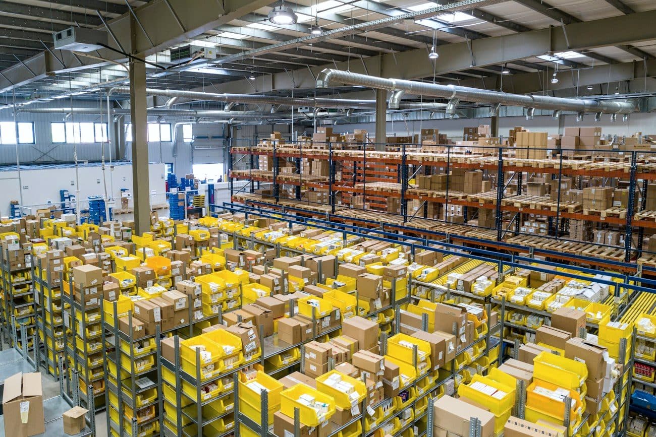 A warehouse aisle stacked with palletised goods.